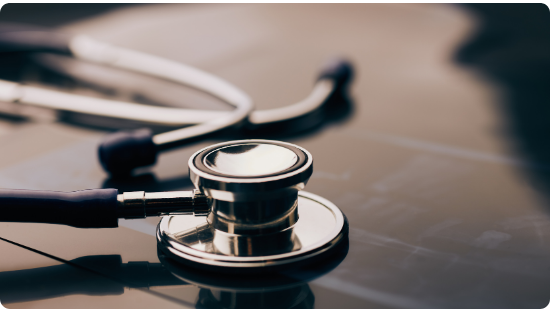 Stethoscope resting on a desk, representing the clinical mission of InHouse Physicians.