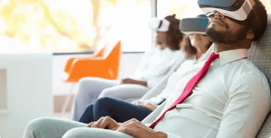 Attendees relaxing in virtual reality headsets during a wellness session run by InHouse Physicians.