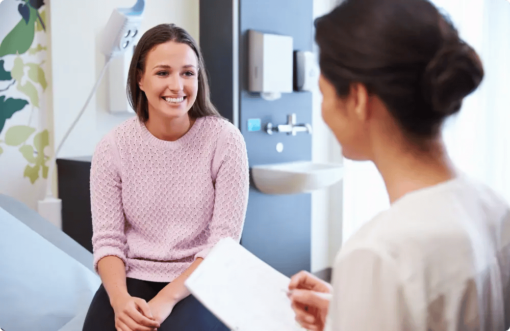 Clinician talking through a specialist referral with a patient at a worksite clinic for InHouse Physicians.