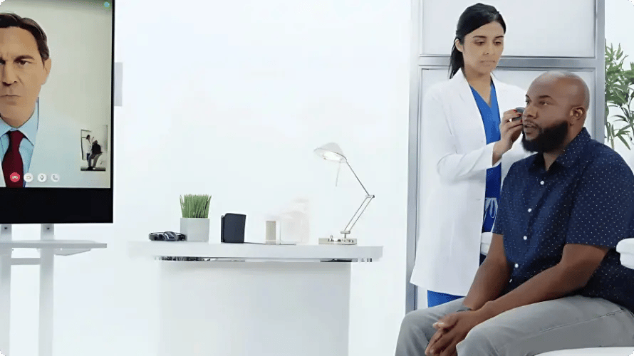 Nurse and patient joined by a doctor on a telehealth screen in an on-site workplace clinic at InHouse Physicians.