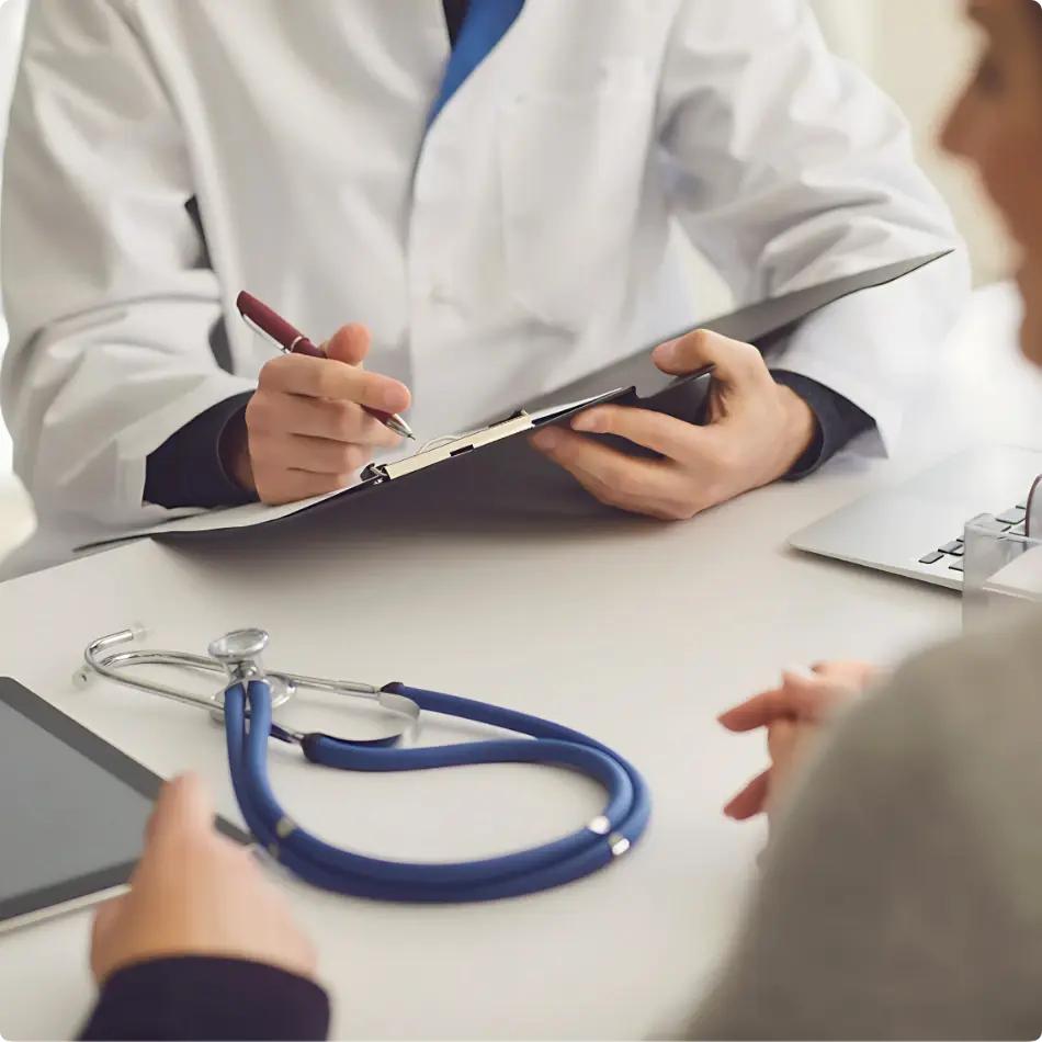 Physician with a stethoscope consulting an attendee at an on-site urgent care clinic for InHouse Physicians.